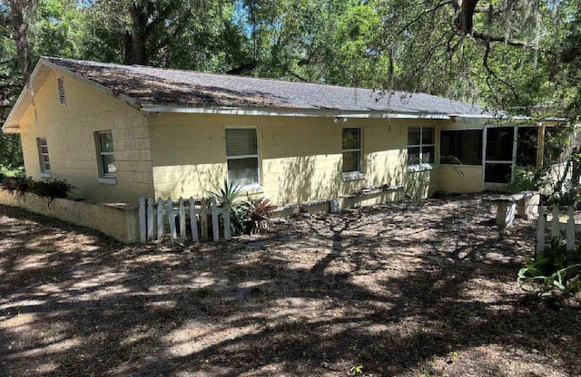 16325 SE 134th Ct, Weirsdale, FL 32195 - view of front facade with roof with shingles, a sunroom, and concrete block siding
