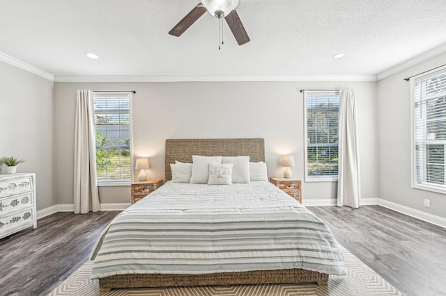 bedroom featuring crown molding, ceiling fan, and dark wood-type flooring