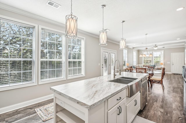 kitchen with white cabinetry, a kitchen island with sink, stainless steel dishwasher, and decorative light fixtures