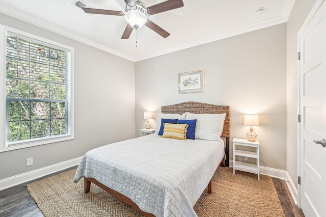 bedroom featuring multiple windows, dark hardwood / wood-style flooring, and ceiling fan