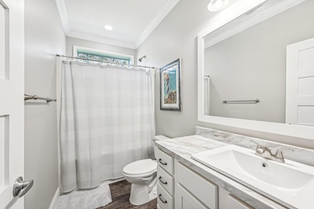 full bathroom featuring crown molding, hardwood / wood-style floors, toilet, shower / tub combo with curtain, and vanity