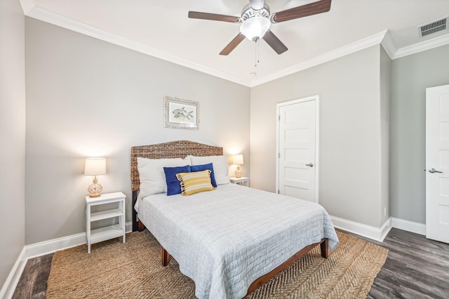 bedroom with ceiling fan, dark hardwood / wood-style floors, and ornamental molding