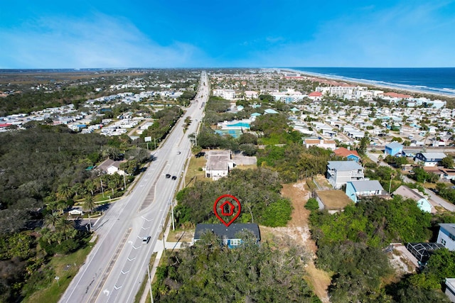 birds eye view of property with a beach view and a water view