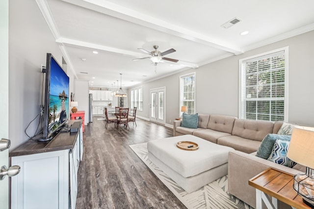 living room with crown molding, ceiling fan, and dark wood-type flooring