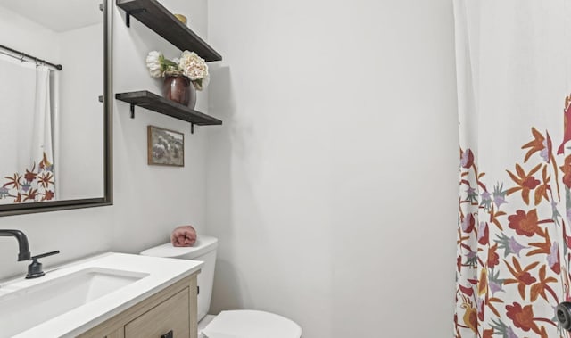 bathroom with vanity and toilet