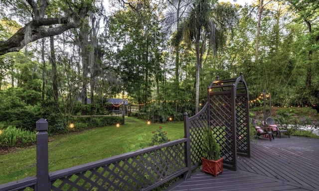 wooden terrace featuring a yard