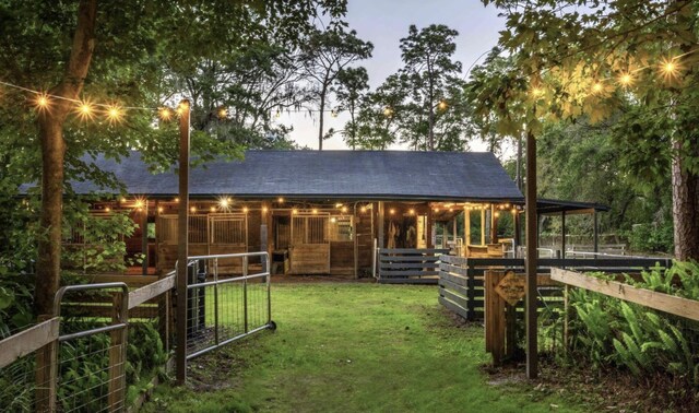 back house at dusk with an outbuilding