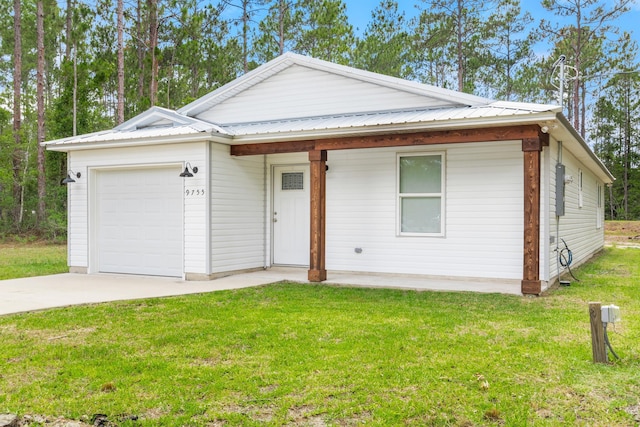 view of front of property with a front yard and a garage