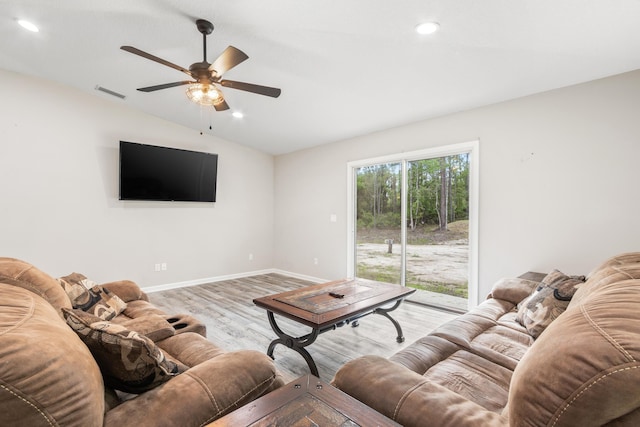 living room featuring ceiling fan, light wood-type flooring, and lofted ceiling