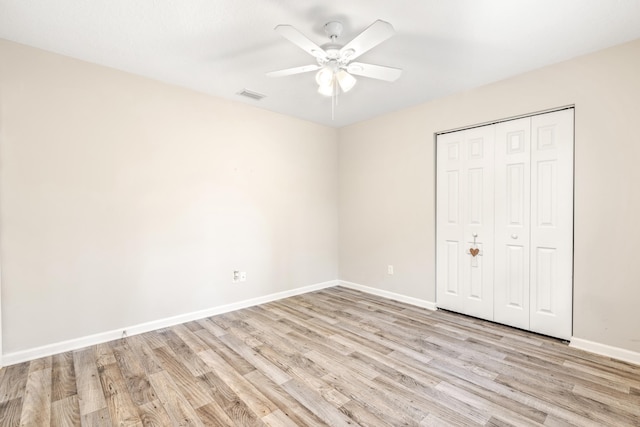 unfurnished bedroom featuring a closet, ceiling fan, and light hardwood / wood-style flooring