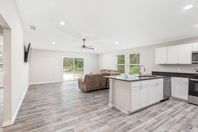 kitchen featuring white cabinets, plenty of natural light, light wood-type flooring, and sink