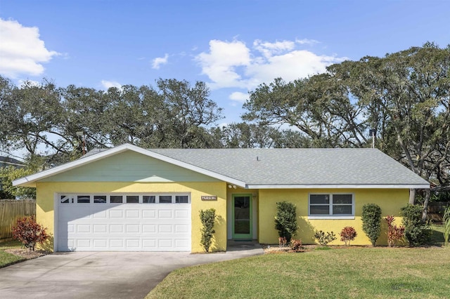 ranch-style house featuring an attached garage, a shingled roof, concrete driveway, stucco siding, and a front yard