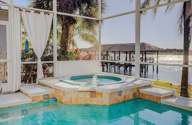 view of swimming pool with an in ground hot tub and a water view