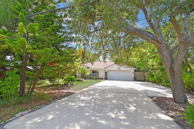 1711 Old Beach Rd, Saint Augustine, FL 32080 - view of front facade featuring driveway, stucco siding, and an attached garage