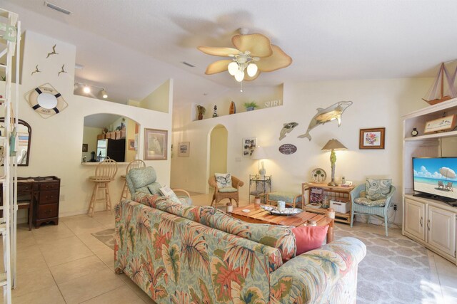 1711 Old Beach Rd, Saint Augustine, FL 32080 - living room featuring arched walkways, ceiling fan, vaulted ceiling, and light tile patterned flooring