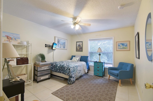 1711 Old Beach Rd, Saint Augustine, FL 32080 - bedroom with light tile patterned flooring, ceiling fan, and a textured ceiling