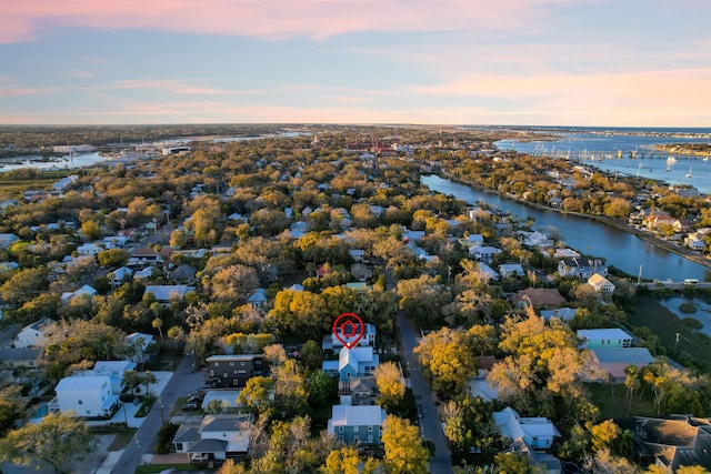 birds eye view of property with a water view and a residential view
