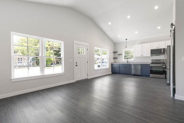 unfurnished living room featuring high vaulted ceiling, recessed lighting, dark wood-style floors, a sink, and baseboards