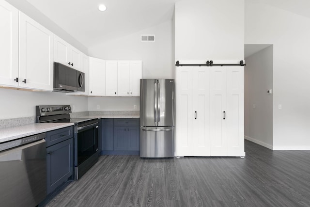 kitchen with stainless steel appliances, dark wood-style flooring, white cabinetry, baseboards, and high vaulted ceiling