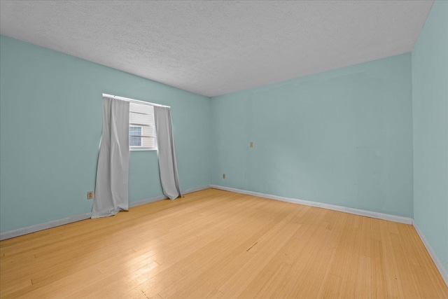 603 Mariposa St, Saint Augustine Beach, FL 32080 - empty room featuring wood finished floors and a textured ceiling