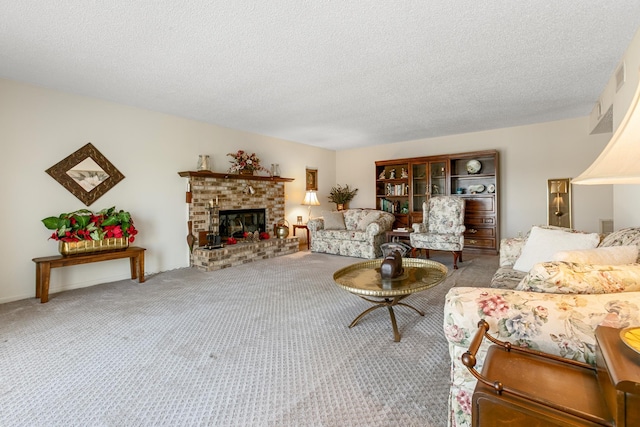 living room with a fireplace, carpet floors, and a textured ceiling