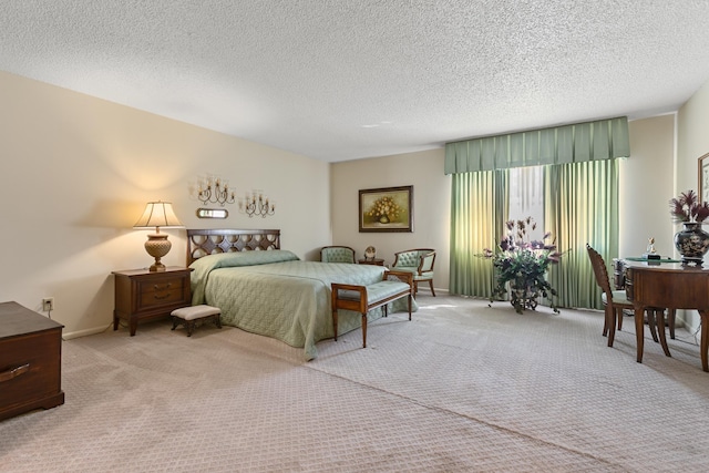 bedroom featuring a textured ceiling and light colored carpet