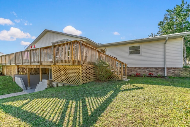 rear view of house featuring a yard and a deck