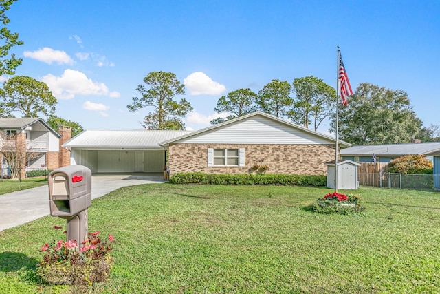 ranch-style home featuring a front yard, a carport, and a storage shed