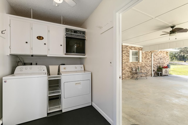 washroom featuring cabinets, brick wall, ceiling fan, and washing machine and clothes dryer