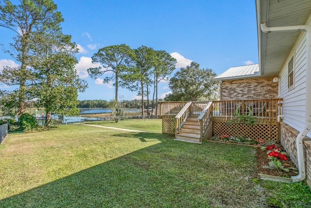 view of yard featuring a deck with water view