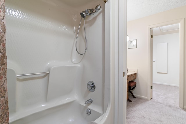 bathroom featuring a textured ceiling and shower / washtub combination