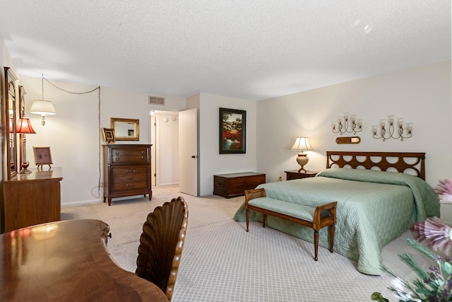 bedroom featuring light colored carpet and a textured ceiling