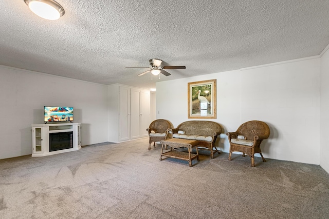 sitting room with carpet flooring, a textured ceiling, and ceiling fan