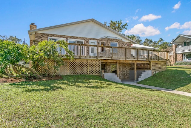 back of property with a deck and a lawn