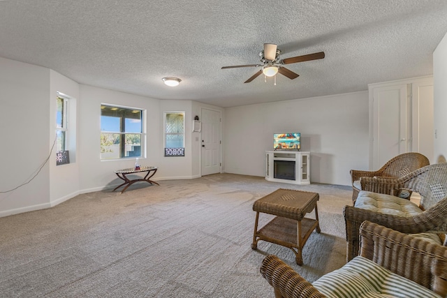 living room with ceiling fan, light carpet, and a textured ceiling