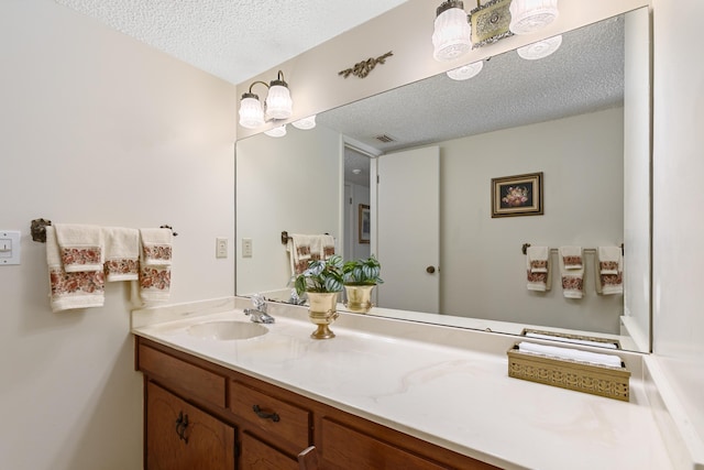 bathroom featuring vanity and a textured ceiling