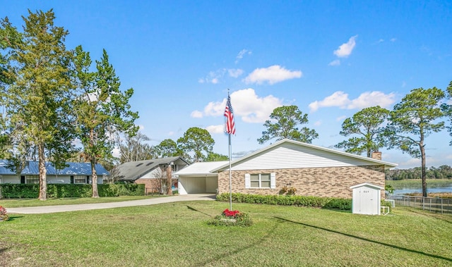 single story home with a front yard and a water view