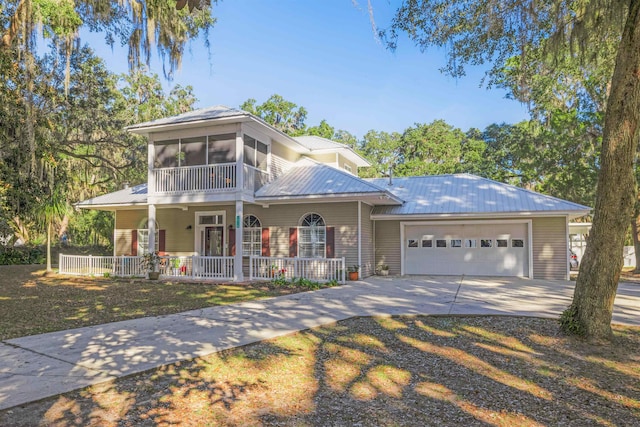 view of front of house with a front lawn, a porch, and a garage