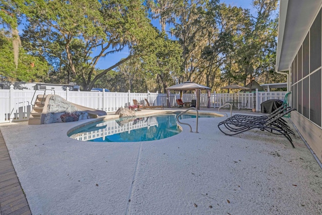 view of pool featuring a gazebo, a patio, and a sunroom