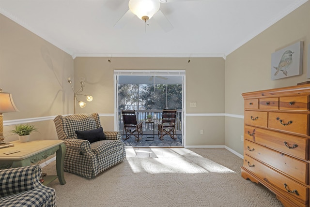 living area with ceiling fan, light carpet, and ornamental molding