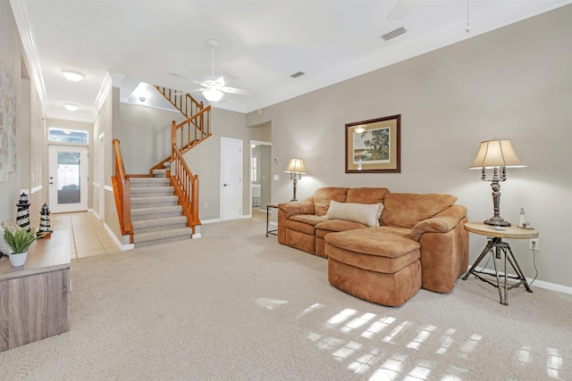 living room featuring ceiling fan, light colored carpet, and ornamental molding