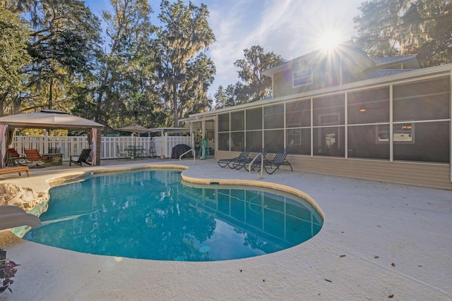 view of pool featuring a gazebo, a sunroom, a water slide, and a patio