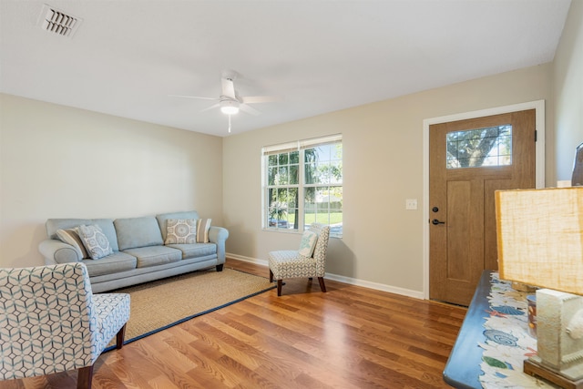 living room featuring hardwood / wood-style flooring and ceiling fan