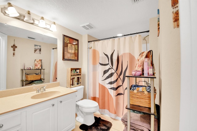 10075 Gate Pkwy Unit 907, Jacksonville, FL 32246 - bathroom with vanity, toilet, tile patterned floors, a textured ceiling, and a shower with curtain