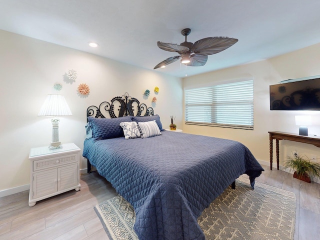 bedroom with light wood-type flooring and ceiling fan