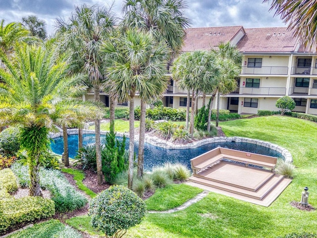 view of pool featuring a lawn