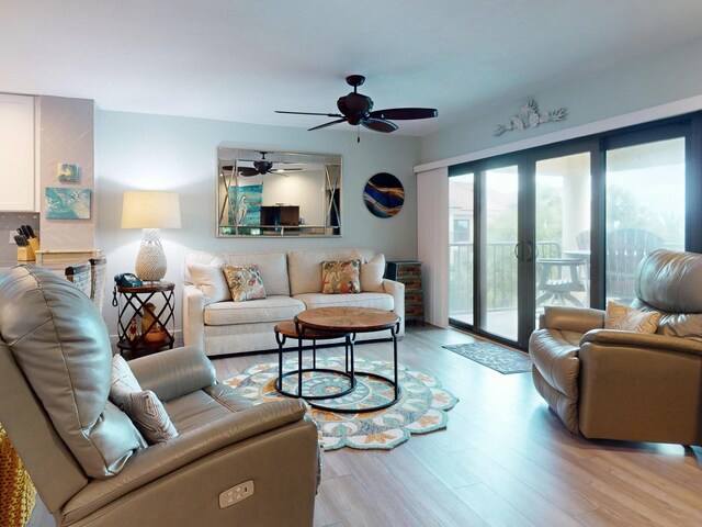 living room with french doors, light hardwood / wood-style flooring, and ceiling fan