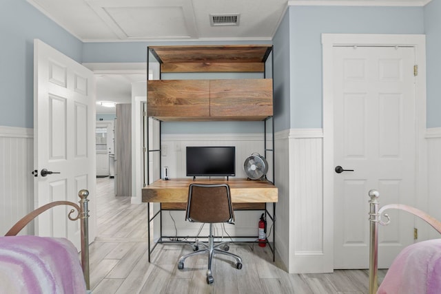 bedroom with visible vents, wainscoting, and wood finished floors