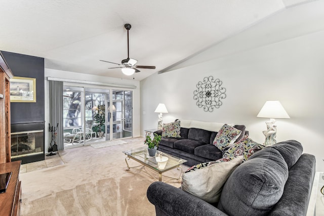 living area featuring light carpet, ceiling fan, and vaulted ceiling