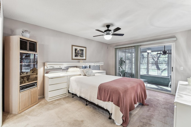 bedroom with light carpet, access to outside, and a ceiling fan